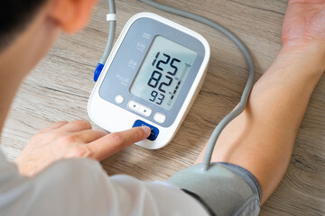 Man check blood pressure monitor and heart rate monitor with digital pressure gauge. Health care...