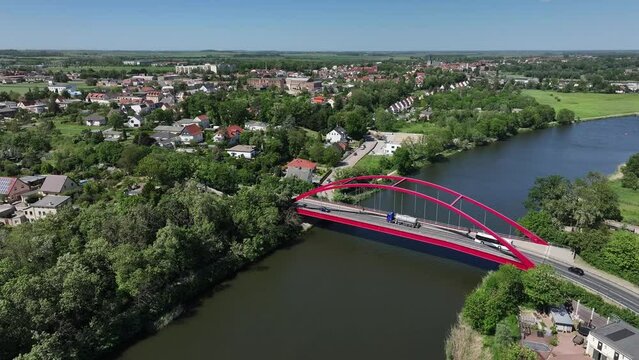 Flight movement in a semicircle along the Saale bridge in Calbe. Small town in Saxony-Anhalt. Vehicles on the bridge over the river Saale. The town centre of Calbe in the background.