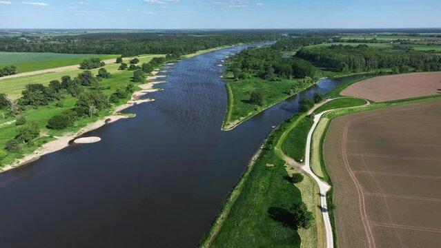 Flight along the Elbe near Barby towards the mouth of the Saale. The Saale river flows into the Elbe river. Landscape in Saxony-Anhalt. Local recreation near Magdeburg.