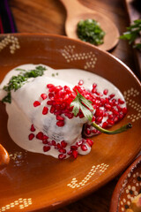 Chiles en Nogada, Typical dish from Mexico. Prepared with poblano chili stuffed with meat and fruits and covered with a walnut sauce. Named as the quintessential Mexican dish for national holidays.