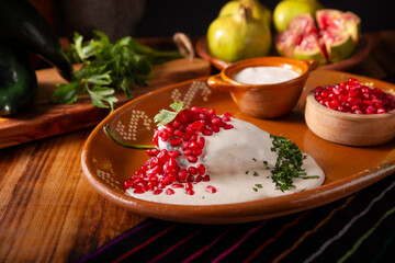 Chiles en Nogada, Typical dish from Mexico. Prepared with poblano chili stuffed with meat and fruits and covered with a walnut sauce. Named as the quintessential Mexican dish for national holidays.