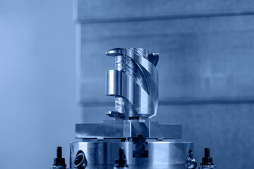 Modern CNC milling machine during operation, blue toning. Produced cutting metal parts, industry heavy factory