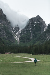 Cheerful Young Woman Hiking Through Scenic Trails in the Alps