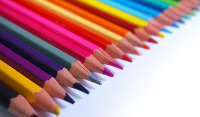Fototapeta premium A diagonal arrangement of sharpened colored pencils with the tips facing the viewer.