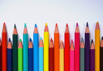 A diagonal arrangement of sharpened colored pencils with the tips facing the viewer.