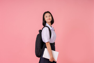 Asian female high school student, tutoring institute presenter, holding a book and looking towards...