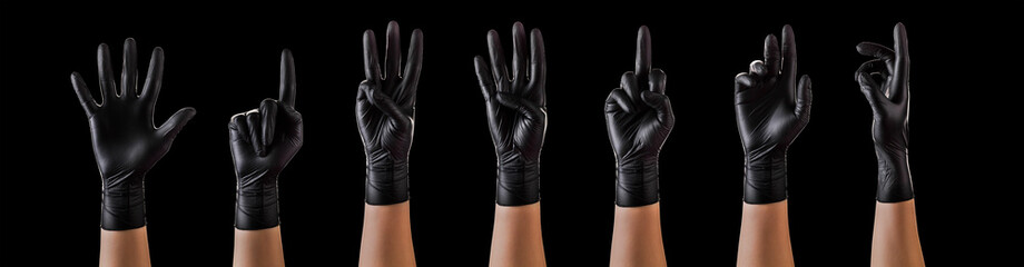 Hands in black gloves showing different gestures, pointing and showing signs