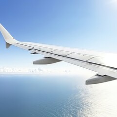 The wing of an airplane flies above the water in the sky