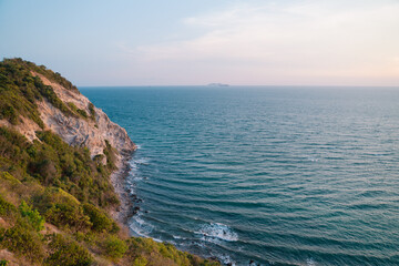 A beautiful ocean view with a rocky cliff in the background