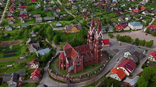 Drone orbiting around St. Jacob catholic church in the small medieval town of Sveksna, Silute