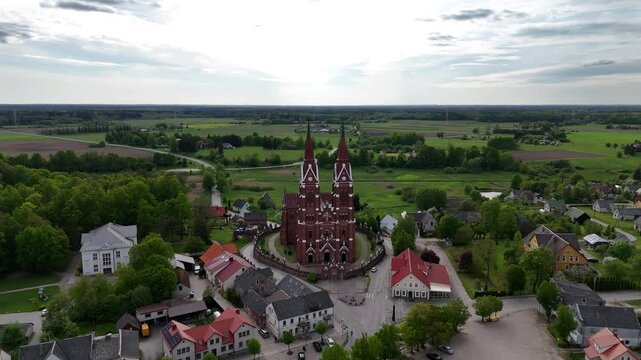 Panoramic drone shot of Sveksna catholic church in the small medieval town of Silute