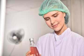 QC manager inspecting the quality of a beverage product in the production process