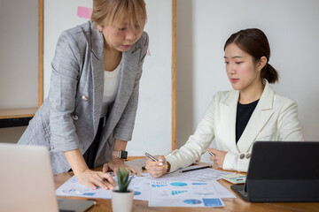 Two businesswoman meeting and data analysis and statistics report for budget an office