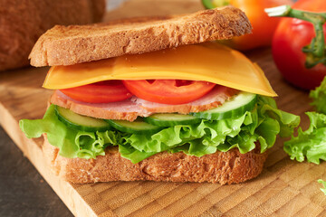 Sandwich with ham and vegetables.  Breakfast preparation.