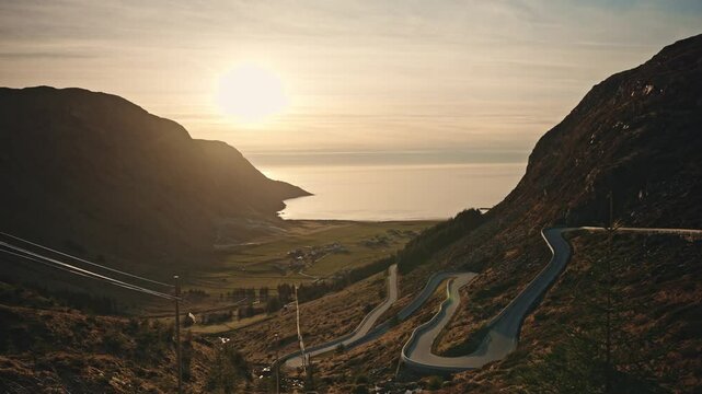 Winding road of Hoddevik during golden sunset, aerial view