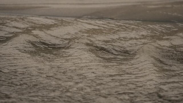 Ocean water flowing over sand in coastal beach