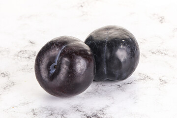 Two ripe sweet black plums