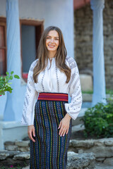 young girl wearing Romanian traditional blouse in the country. Authentic national costume of the Romanian tradition.