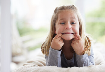 Portrait, funny face and girl child in bedroom for comedy, holiday and smile for weekend in home....