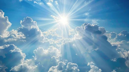 Blue sky with soft clouds and the sun peeping behind a white cloud © AkuAku