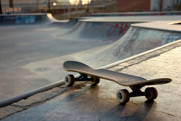 An empty urban skatepark with a skateboard, ready for extreme sports and freestyle action
