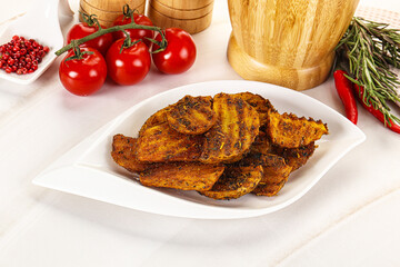 Golden baked potato Idaho with spices