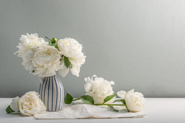 Fragrant white peonies in a vase. Summer mood, decoration. Greeting card, copy space