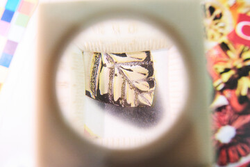 A close up detail magnifying glass showing the dot matrix printing technique using half tone and...
