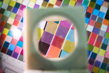 A close up detail magnifying glass showing the dot matrix printing technique using half tone and cmyk print inks. Large format printing for advertising and cardboard box graphics and logos.