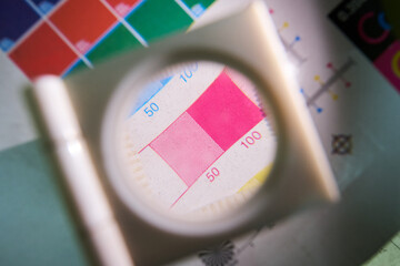 A close up detail magnifying glass showing the dot matrix printing technique using half tone and...