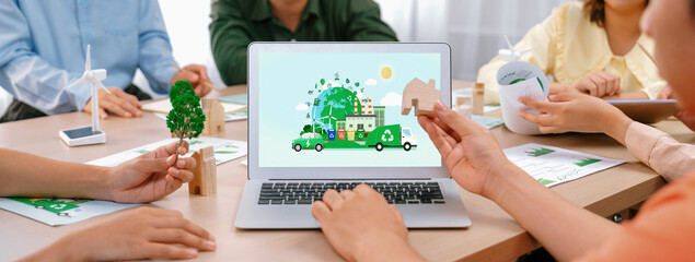 Green city and waste management illustrate displayed on laptop. Business team presenting green...