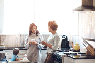Mom, grandmother and baby in kitchen for love, support and coffee in family home. Women, talking...