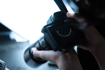 Male hands holding professional camera, take photo in studio