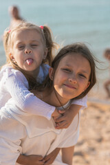 Fototapeta na wymiar Sister's children relax, play and have fun on the sandy seashore