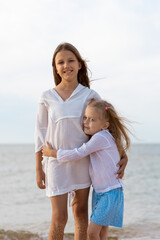 Sister's children relax, play and have fun on the sandy seashore