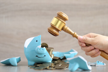 Financial problem, Woman hand holding gavel wooden and broken piggy bank on wooden...