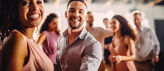 Young man and woman happily practicing swing dance with diverse group of dancers in modern class...