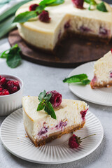Cheesecake with raspberries. A piece of cheesecake with raspberries and mint.