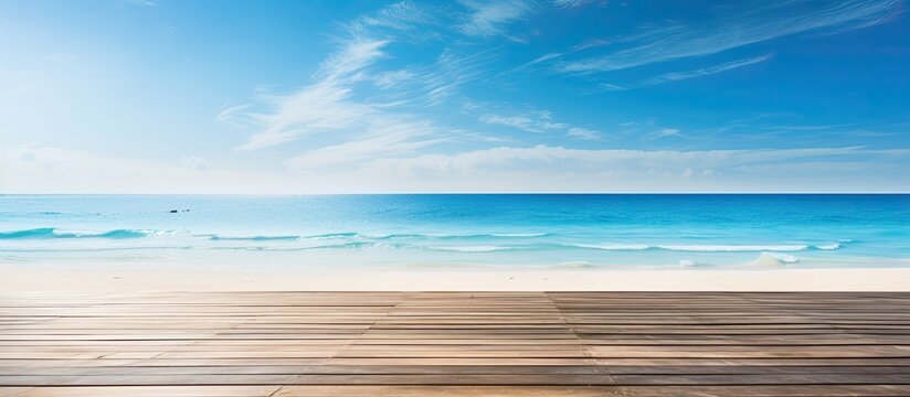 A serene summer beach scene with a wooden deck table overlooking the blue water and sunny sky creating a perfect backdrop for a vacation with a tropical outdoor atmosphere and copy space image