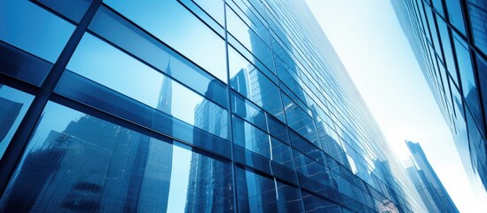 Steel blue glass high rise building skyscrapers exhibit an underside panoramic view with a unique industrial architectural perspective creating a visually stunning copy space image