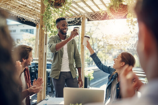 Business people, coffee and cheers with applause for meeting, team building or discussion at outdoor cafe. Young male person or happy group of employees clapping or toast for promotion at restaurant