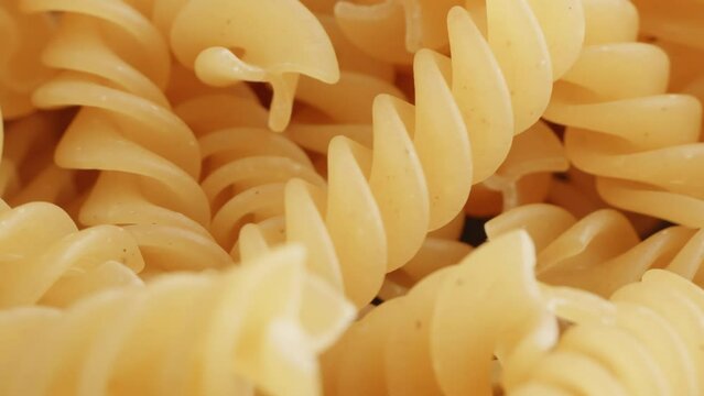 Fusilli pasta fresh extreme close up with a rotating camera move stock footage