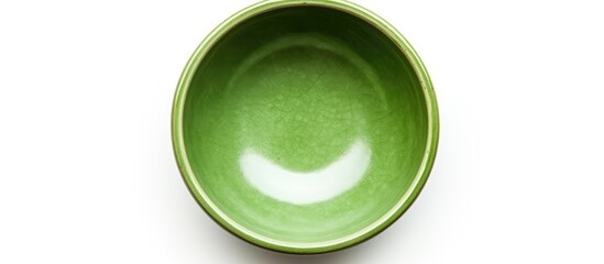 Top view copy space image of a fresh empty green ceramic bowl on a white background