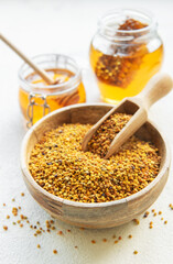 Raw organic bee pollen and honey in jars. .
