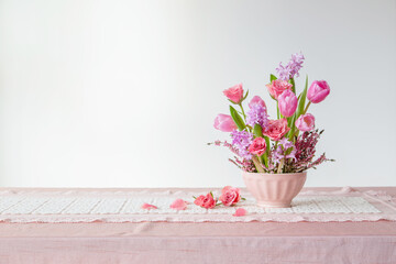 pink flowers in vase on background white wall