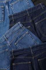 Close-up of blue jeans back pockets in various shades of blue denim.