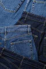 Fototapeta premium Close-up of blue jeans back pockets in various shades of blue denim.