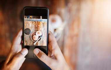 Hands, person and smartphone for coffee photography in table at cafe for art, project or social media post. Influencer, food and screen with cup at restaurant for lunch or break with mobile app