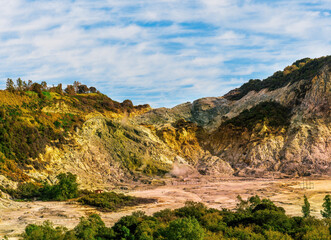 landscape of Plegrean volcano fields in Naples Italy near Pompeii with sulfur yellow caldera duribg eruption of smoke. campi Flegrei and cataclysm of Earthquake