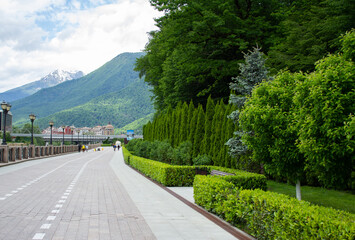 Rosa Khutor embankment, mountains and green forest. Krasnaya Polyana, Sochi.